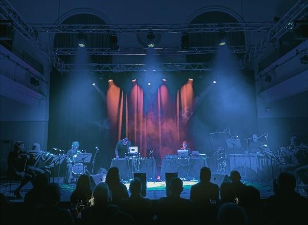 Michael Begg and The Black Glass Ensemble perform on stage at The Queen's Hall