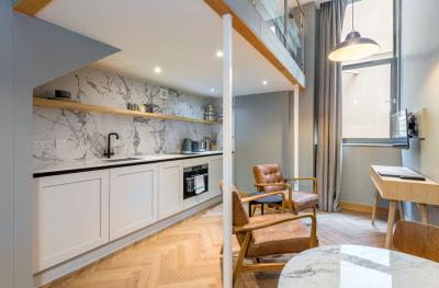 A studio apartment showing a kitchen diner with a mezzanine level above