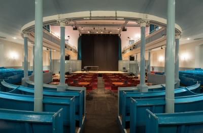 The Queen's Hall auditorium from stalls to stage with cabaret tables