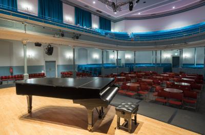 The Queen's Hall auditorium out from stage with cabaret tables