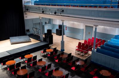 A view from above of round tables with red chairs around them