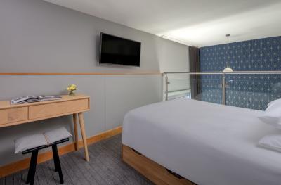 A bed, desk and TV in a mezzanine bedroom