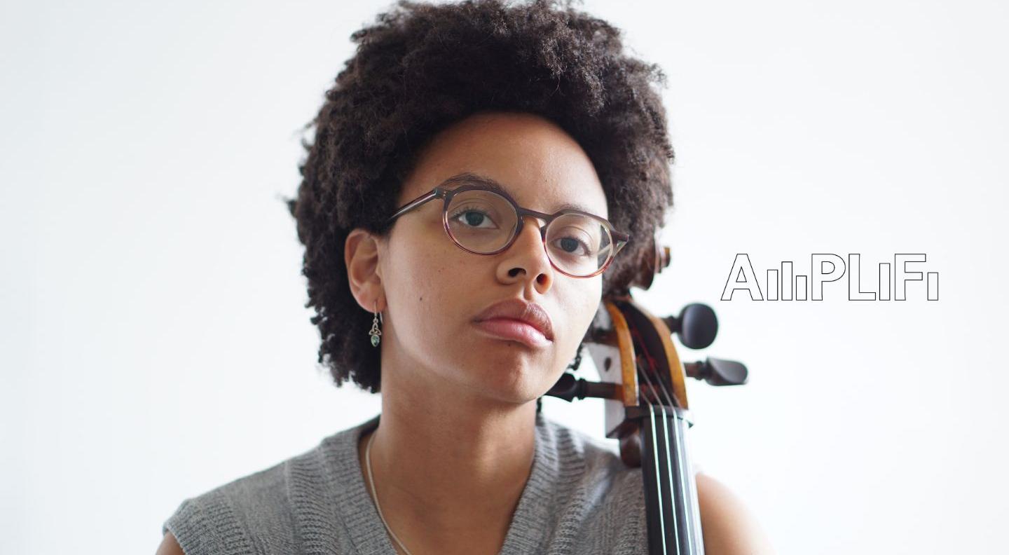 Simone Seales is pictured against a white background holding a cello