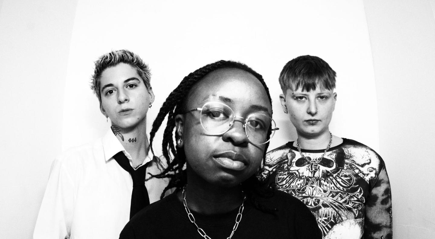 A photo of the three members of Uninvited in black and white