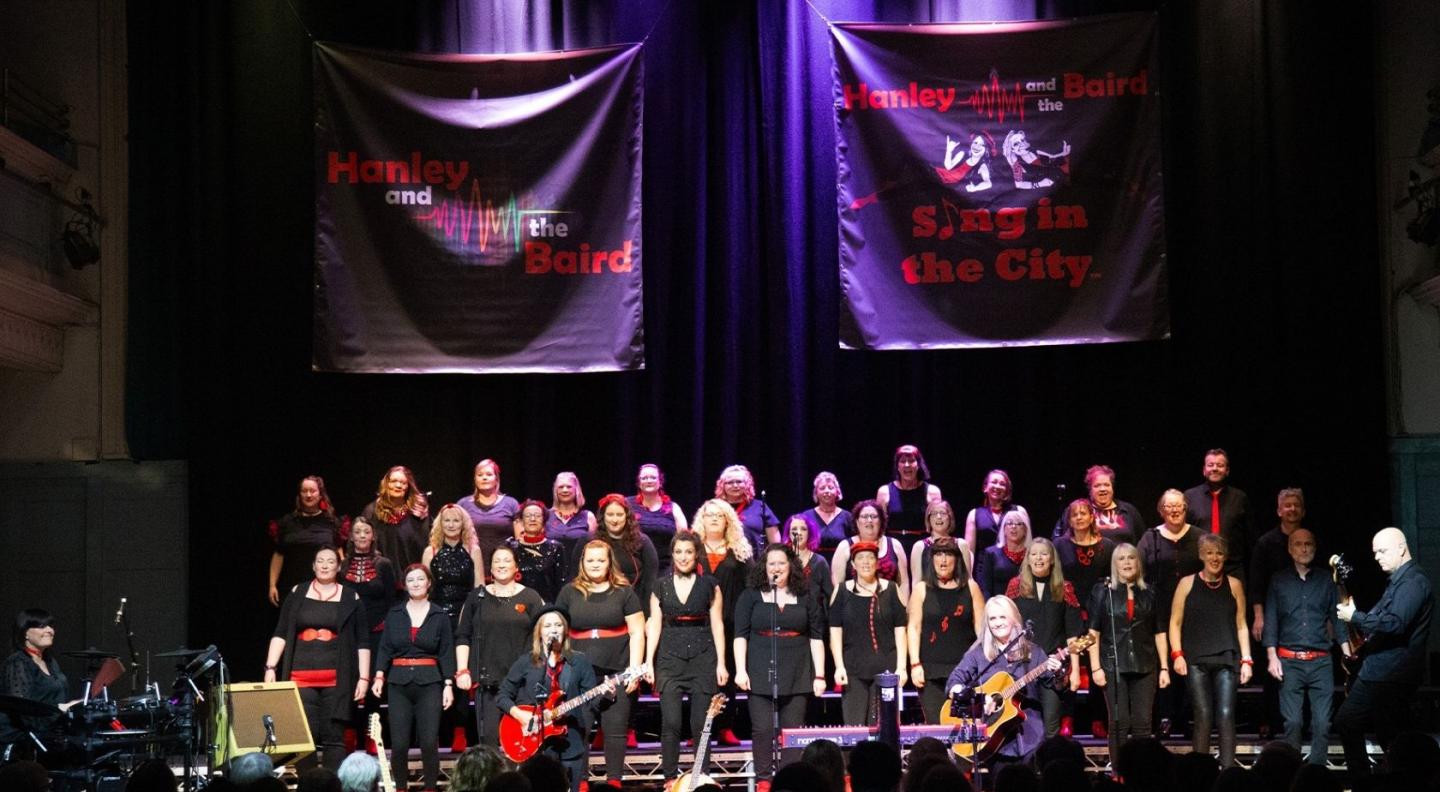 A choir all dressed in black on stage