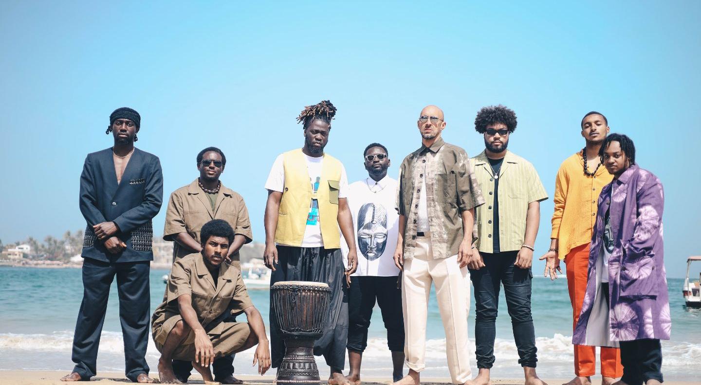 an image of the musicians of the Baliimaya Project on a beach