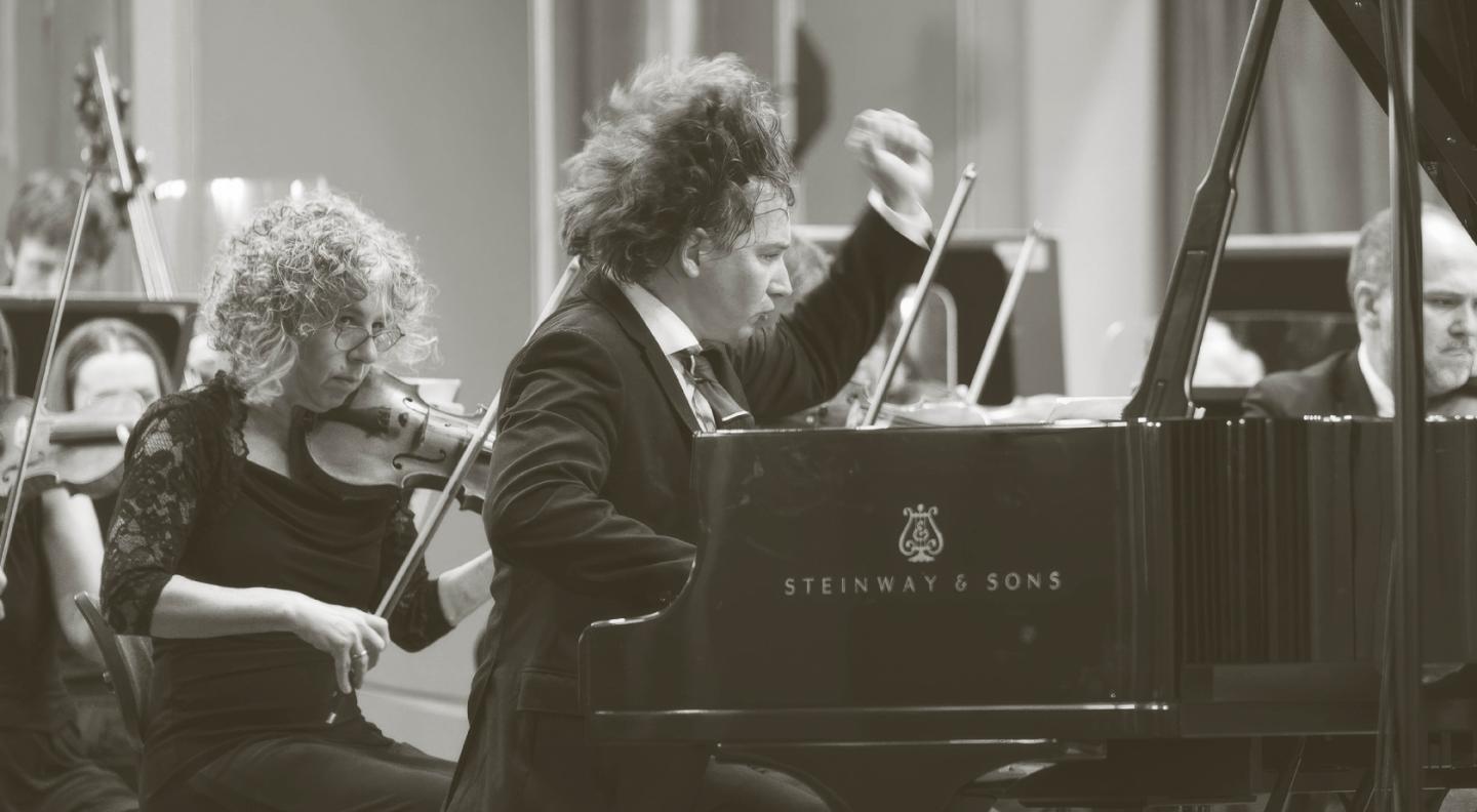 A pianist plays the piano expressively 