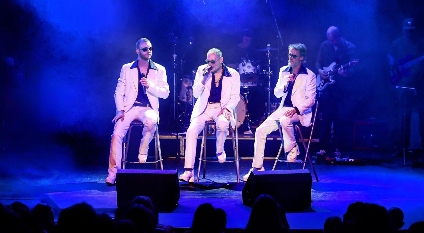 The three members of the Magic of the Bee Gees performing on stage