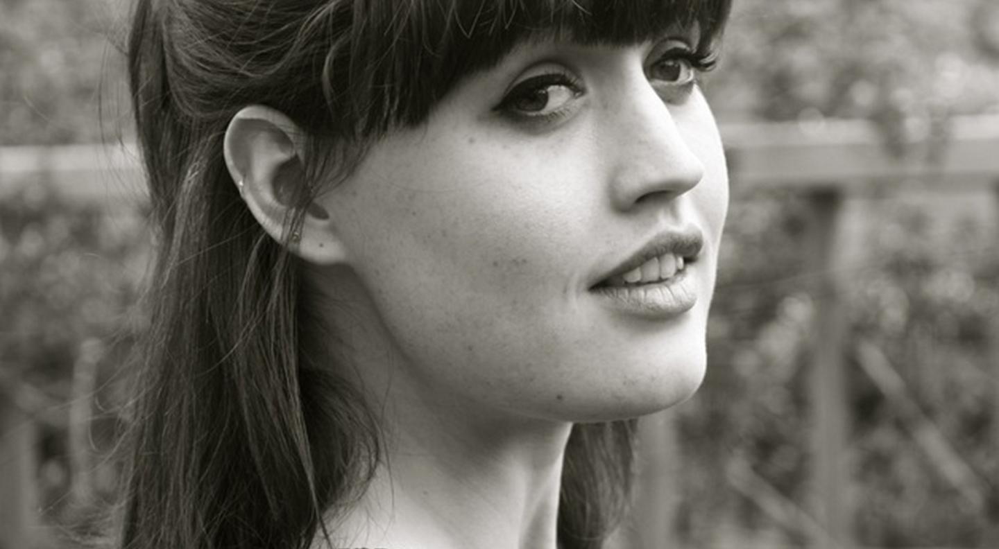 A black and white head shot of Bethan Langford seen from the side looking into the distance.