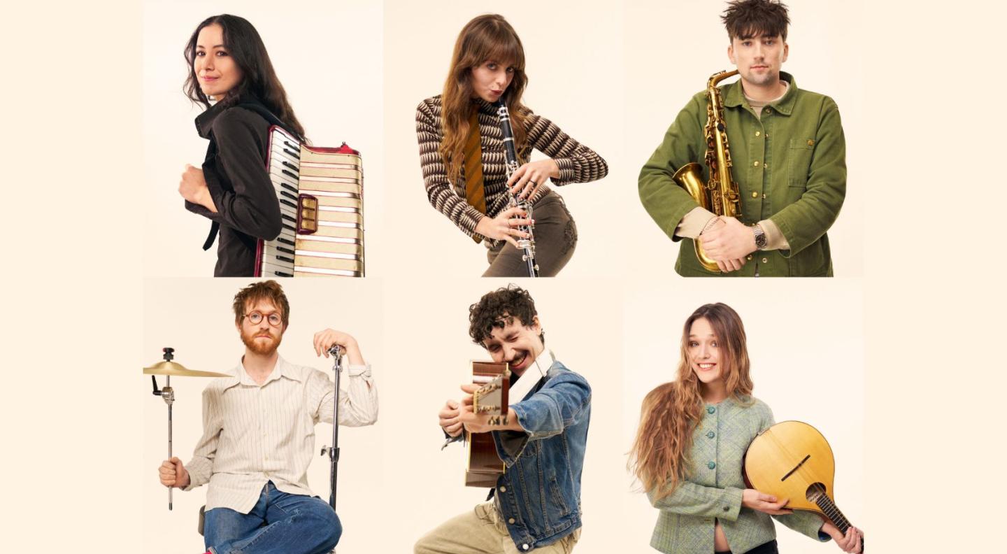 The performers from the group Black Country, New Road posing with their instruments against a beige background
