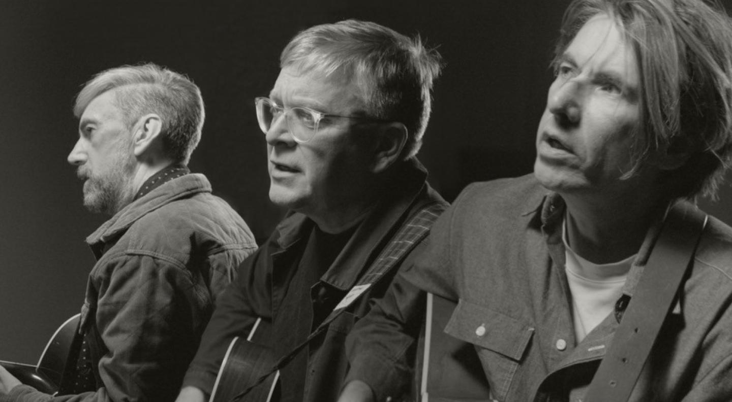 A black and white image of Blake Butler & Grant, each with a guitar, singing