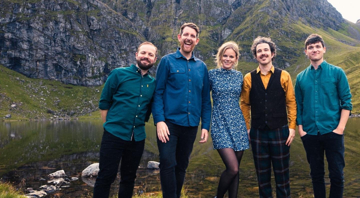 Breabach band standing outside in a Highland scene
