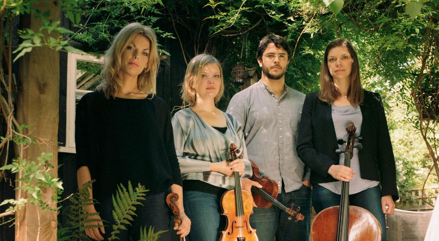 an image of the four members of the quartet in a garden