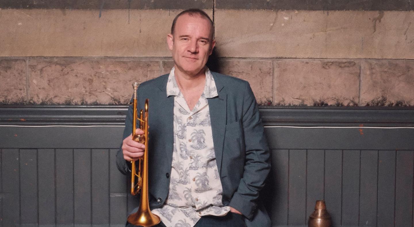 Colin Steele holding his trumpet.