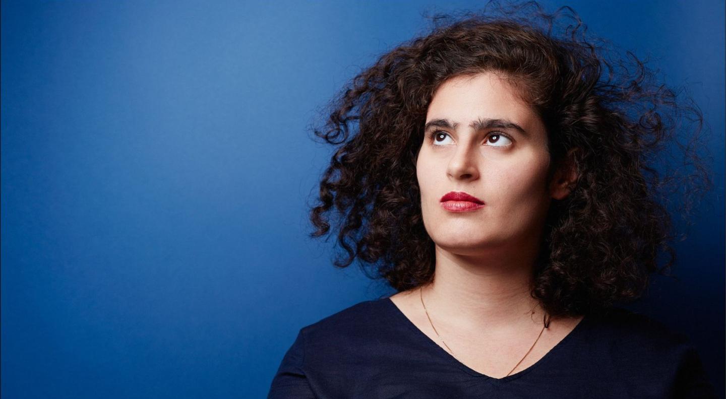 Lillian Gordis standing in front of a blue background
