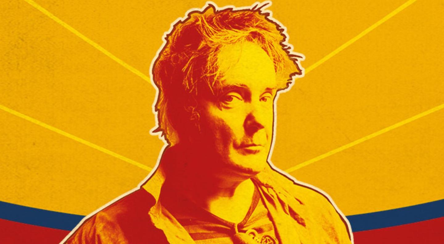 A photo of Dylan Moran with a yellow overlay