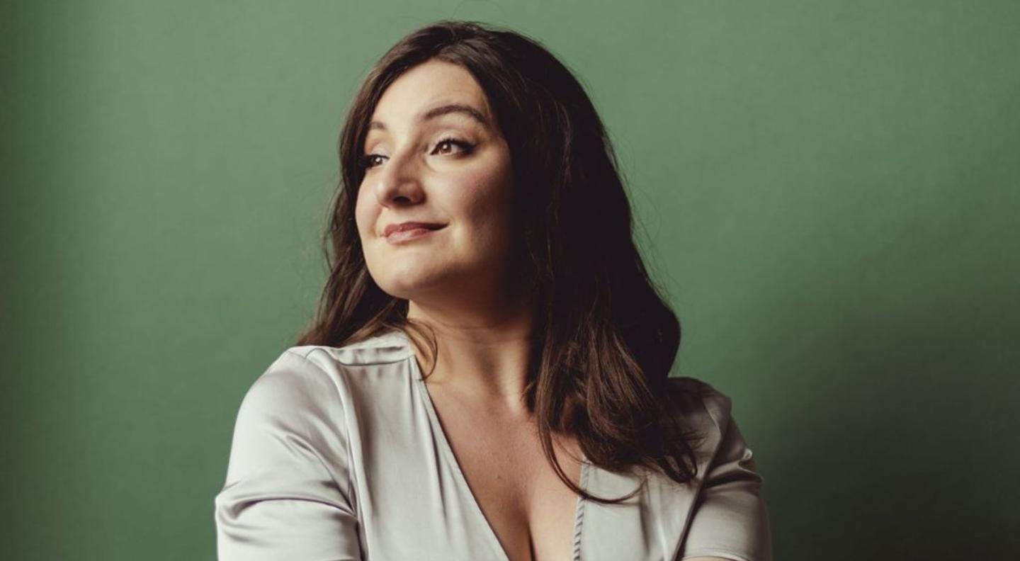 Beth Taylor in front of a green background