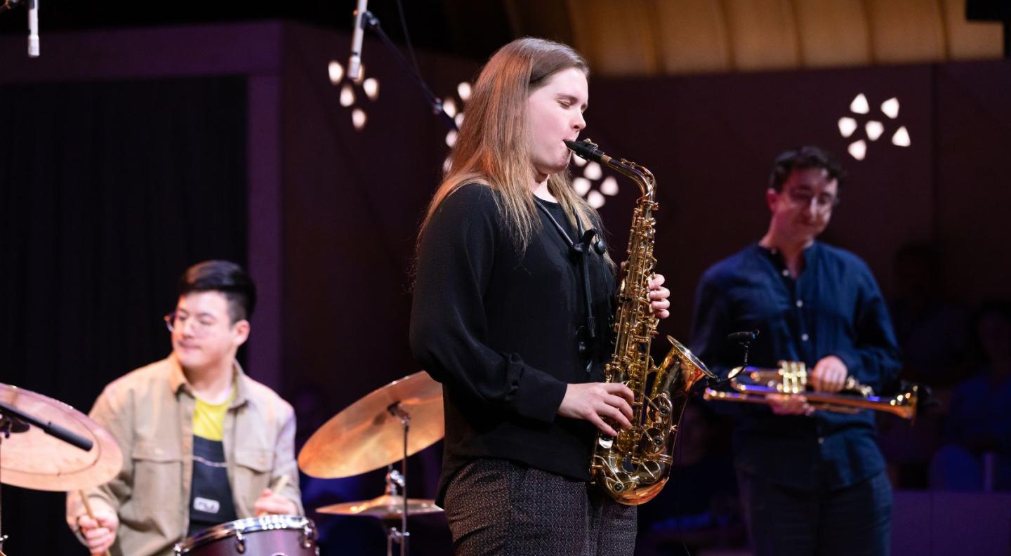 A woman playing the saxophone