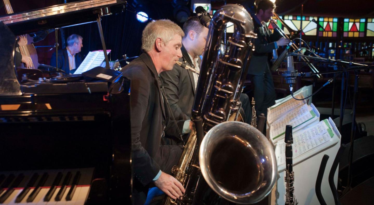 A musician playing the baritone saxophone