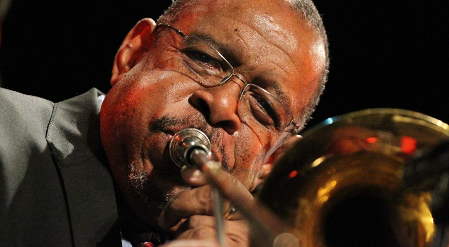 A photograph of Fred Wesley playing the trombone