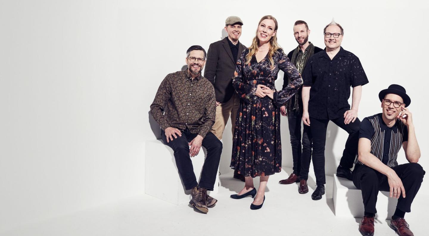 Finnish folk music band Frigg - five men and one woman against a white background