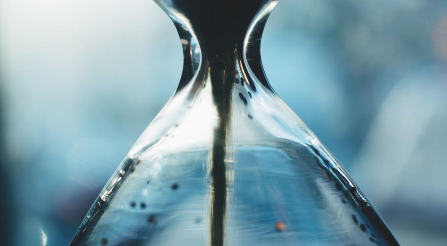 Sand running through an hourglass