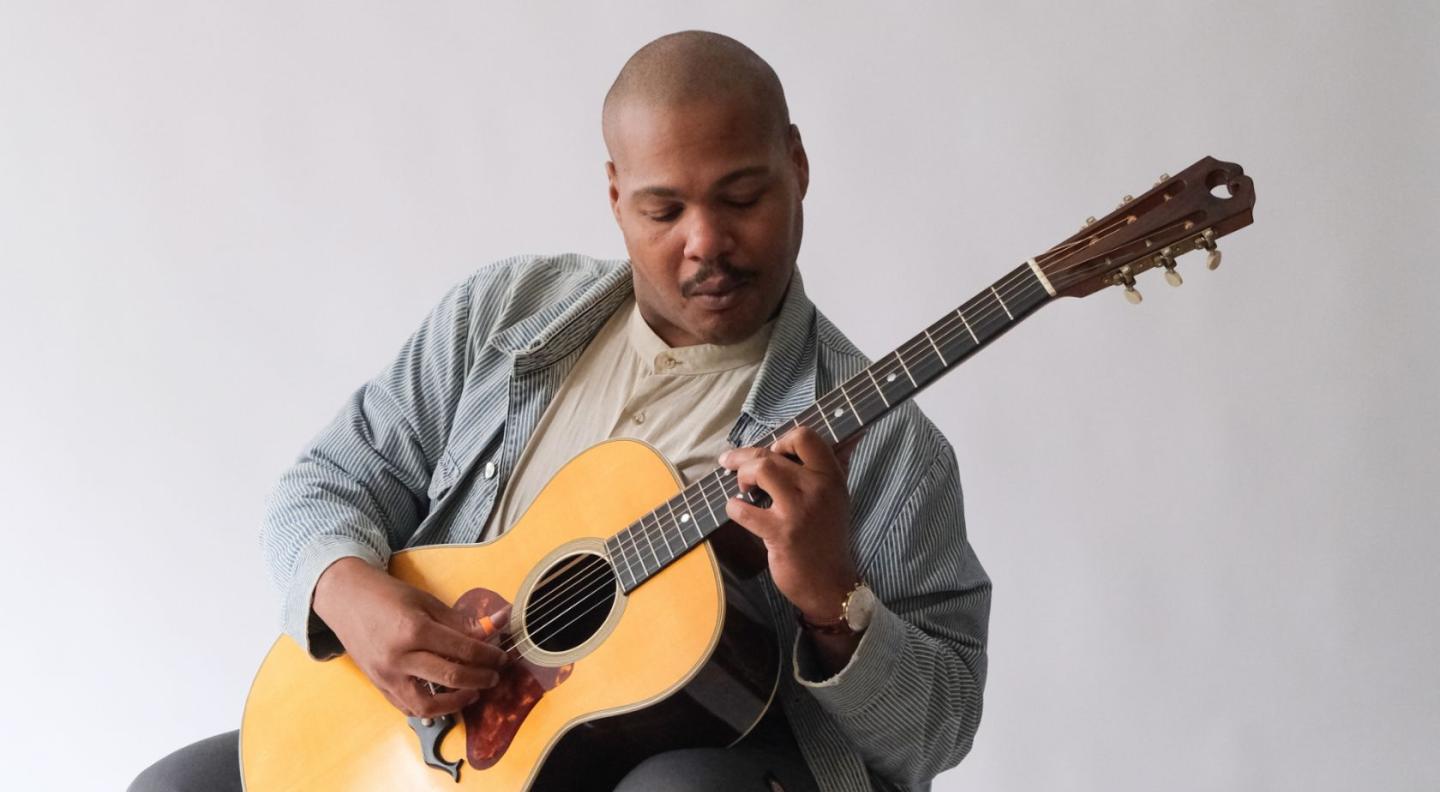 Jerron Paxton playing the guitar