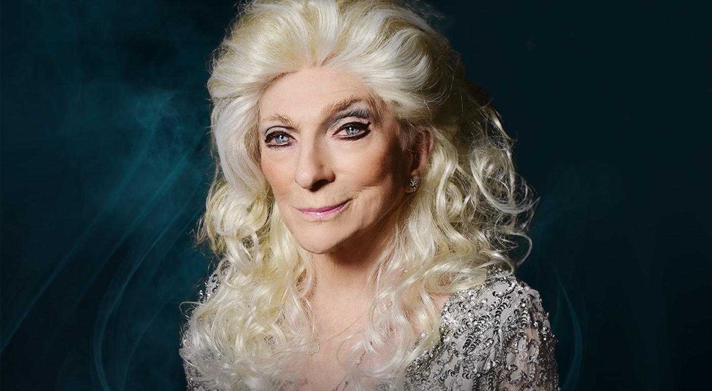 A mid shot of Judy Collins against a black background