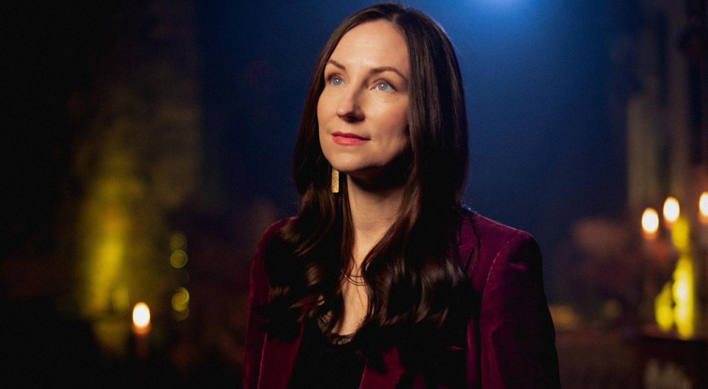 Julie Fowlis, a white woman with long brown hair, wearing a maroon blazer