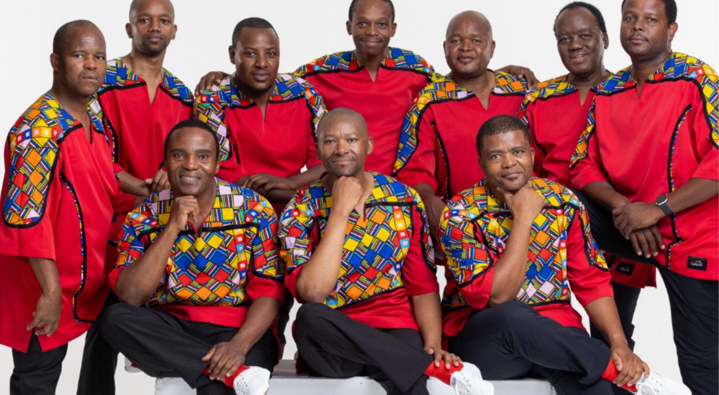 Ladysmith Black Mambazo - a group of men in colour shirts posing for the camera