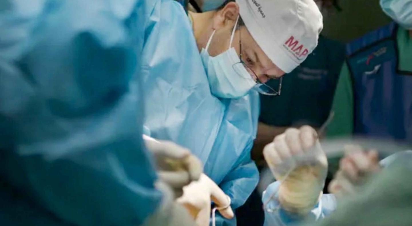 A surgeon in the operating room working to rescue a patient