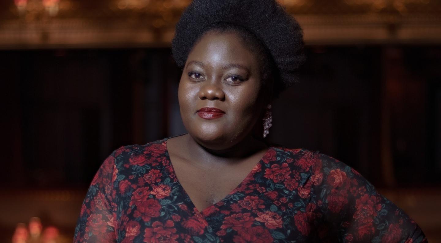 Masabane Cecilia stands, ready to sing, in a theatre