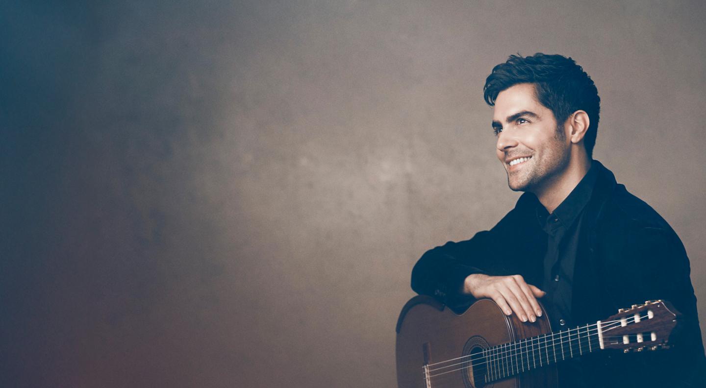 Classical guitarist Milos posing with guitar