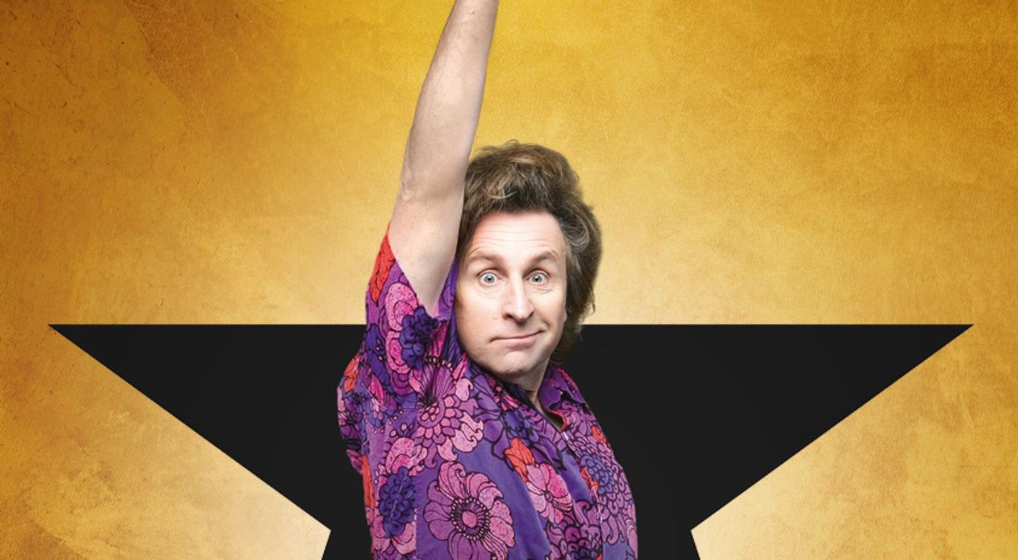 An image of Milton jones holding up a microphone