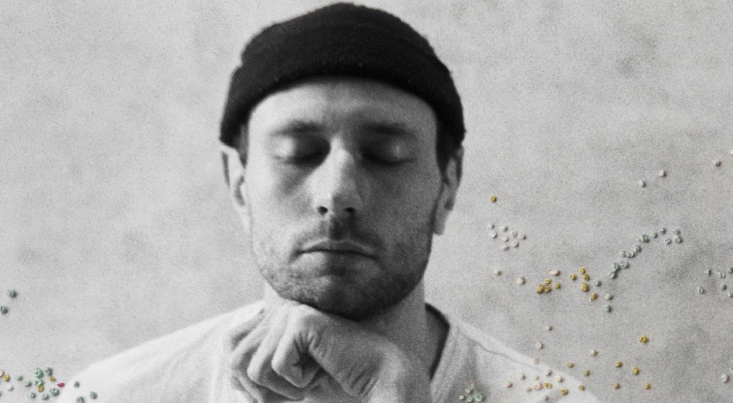 Novo Amor, Ali Lacey, rests his head on his hand and closes his eyes