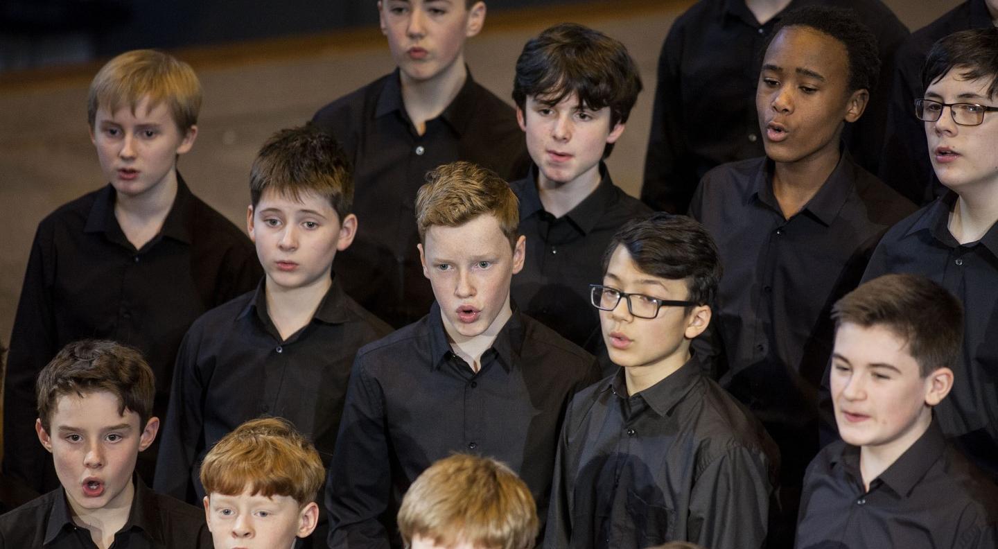 A choir of boys wearing black shirts