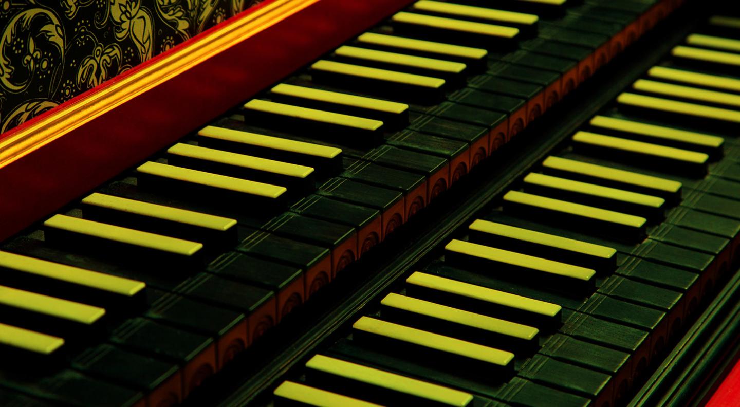 A close up of an ornate piano keyboard
