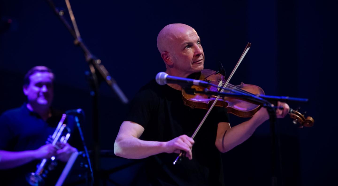 John McCusker playing fiddle live on stage