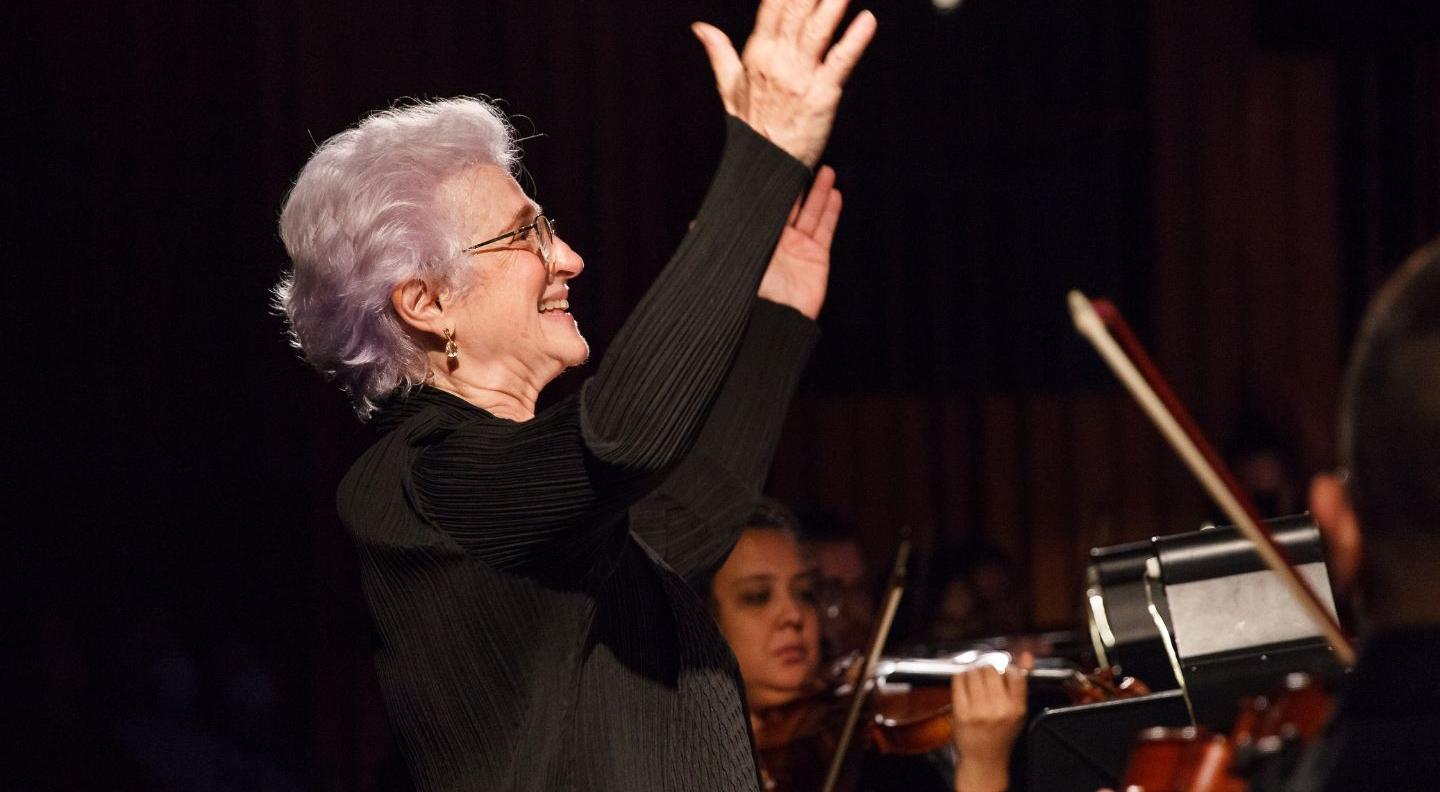 A woman conducts an orchestra