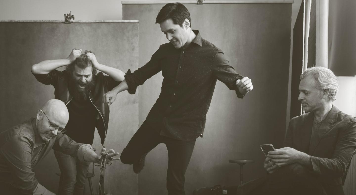 A black and white photo of Brooklyn Rider dancing to music 