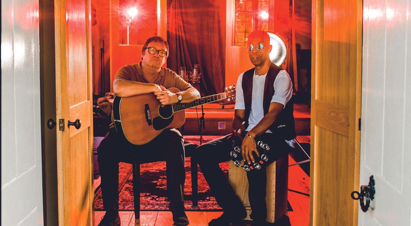 an image of simon and oscar sitting on chairs in a doorway