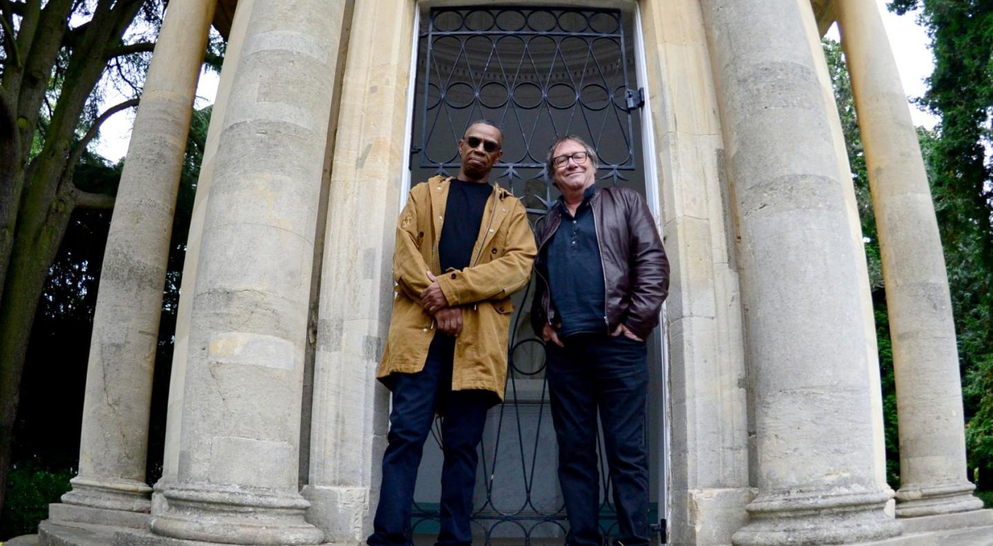 Simon and Oscar standing in front of a building