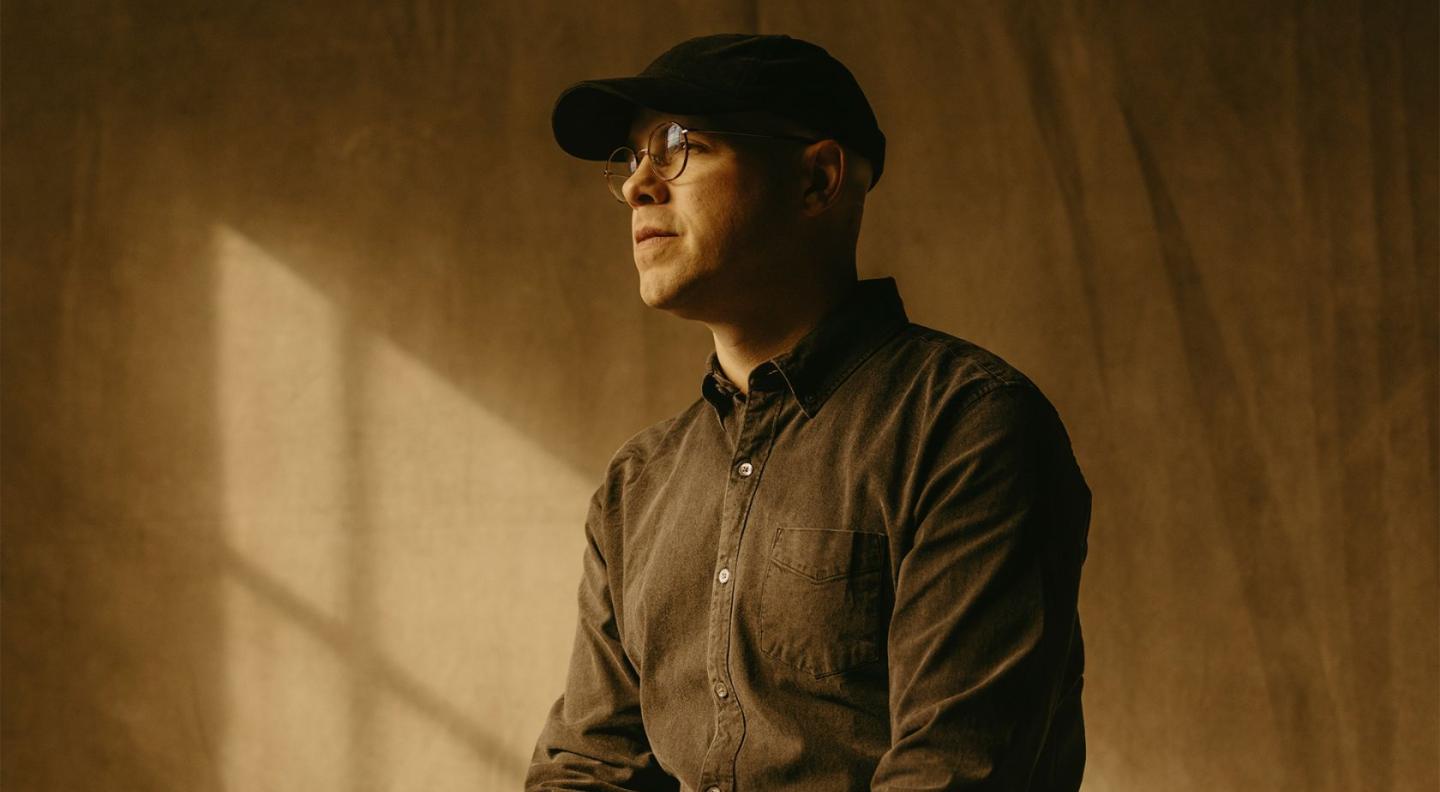 Sleeping at Last in front of a back wall