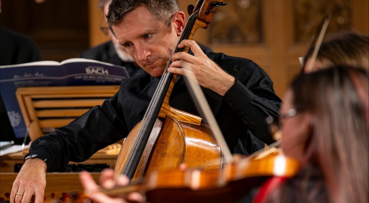 A cellist playing the cello with a bow