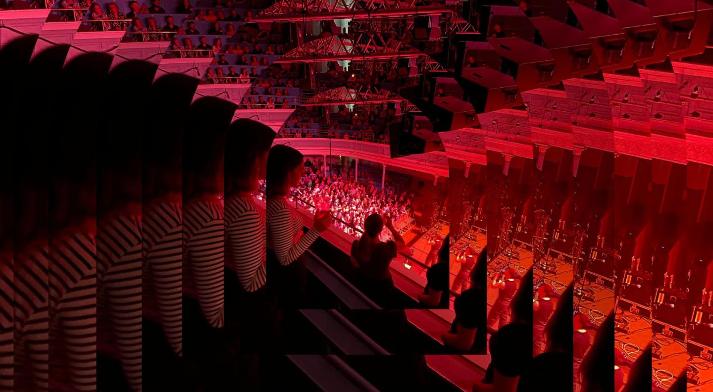 A tiled red image of audience members standing in the auditorium gallery looking down at a crowd of people watching Joesef, a young white man, perform on stage