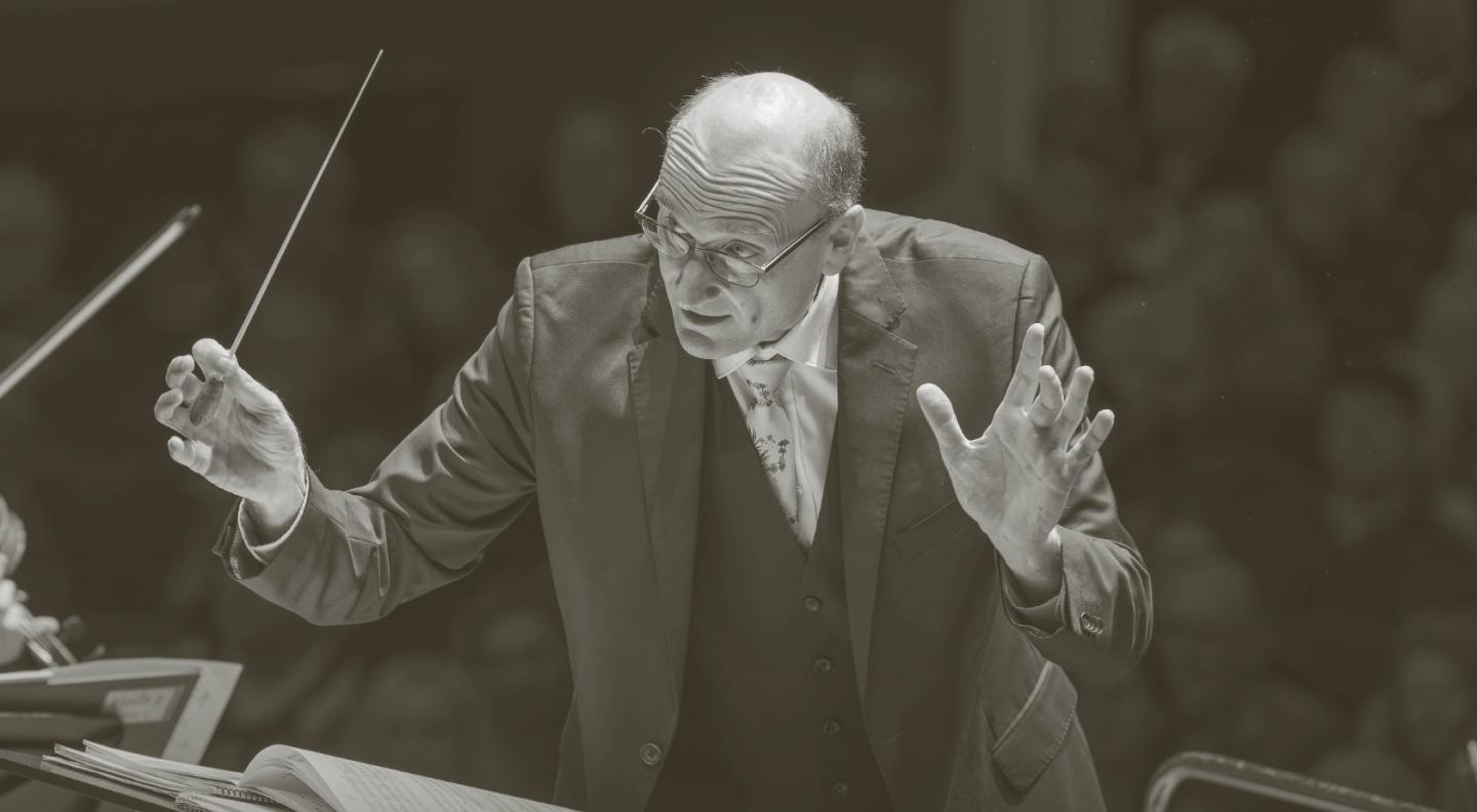 A conductor leads the orchestra for Tchaikovsky's Serenade