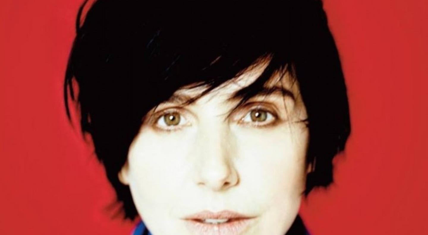 A close up shot of Sharleen Spiteri's face against a bold red background