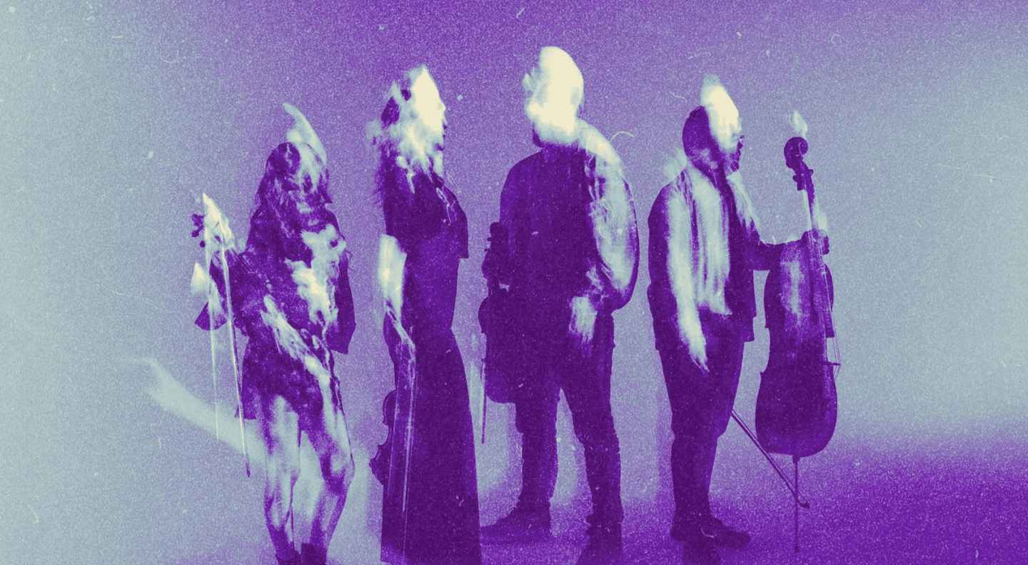 The members of Vitamin String Quartet standing in a line holding their instruments