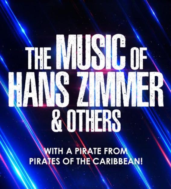 Music of Hans Zimmer being performed live on stage by an orchestra