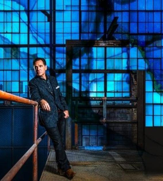 Kurt Elling standing in an industrial setting with many shades of blue
